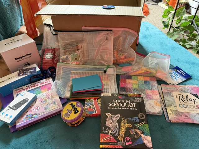 Picture of a large box with games, beads, cards and other creative materials for Guiding sessions.